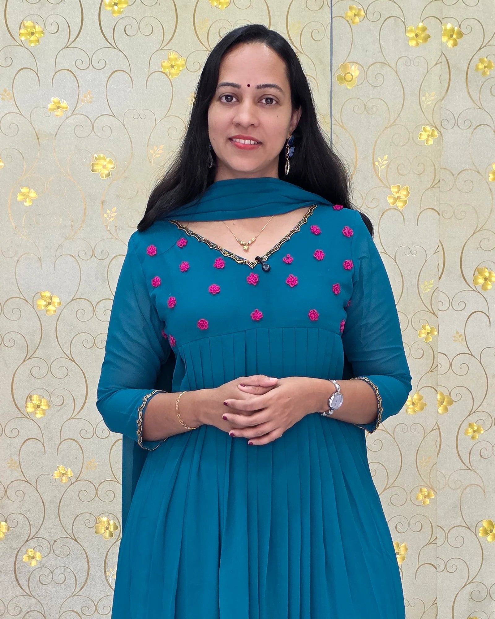 Close-up view of Teal Blue Georgette Salwar Suit with pink floral embroidery and V-neck line by Dritha Designs Kerala DD1205