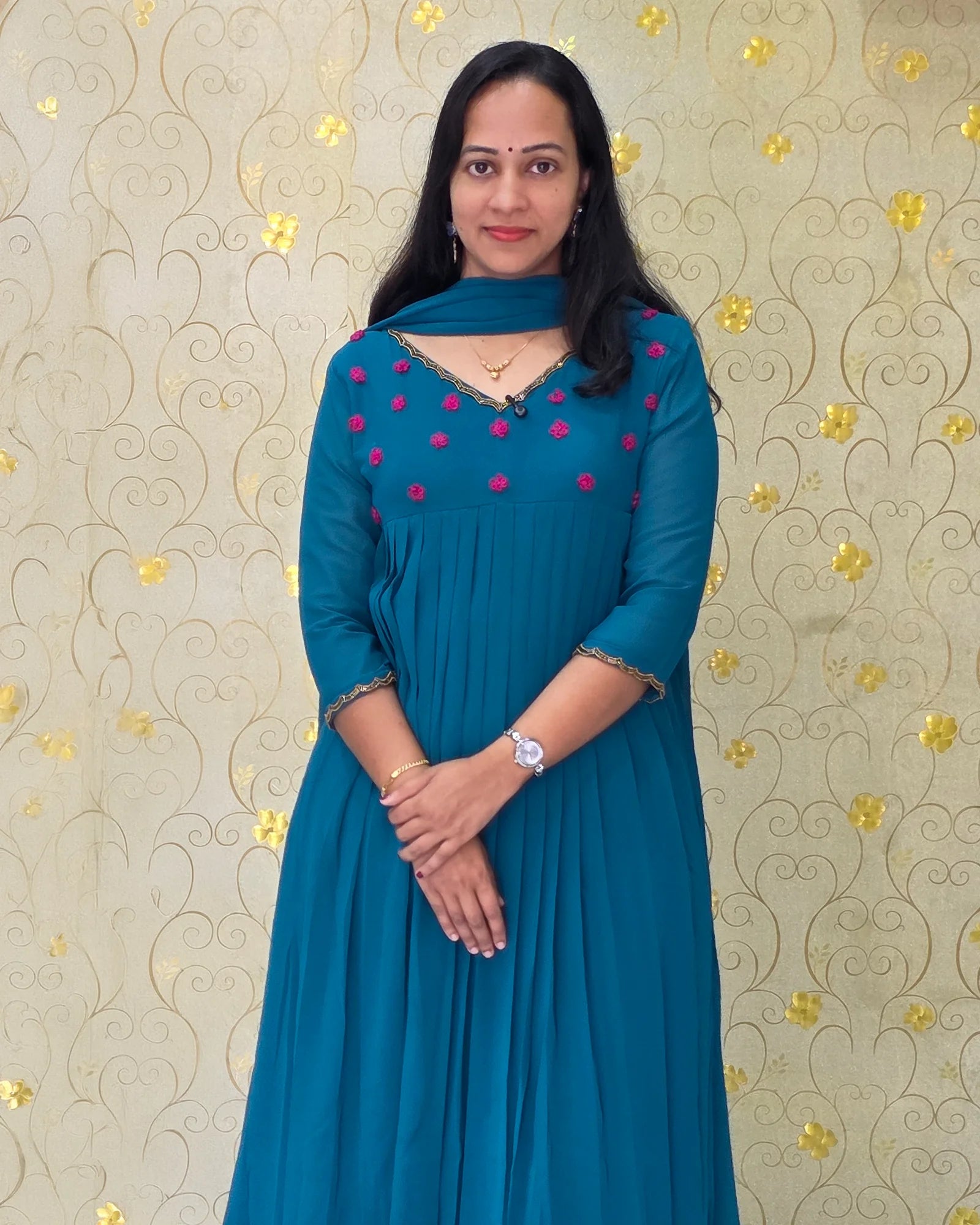 Mid-length shot of woman wearing Teal Blue Georgette pleated salwar suit with 3/4 sleeves by Dritha Designs online boutique DD1205